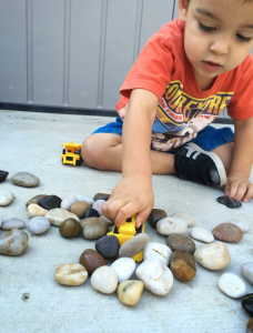 Child playing with rocks